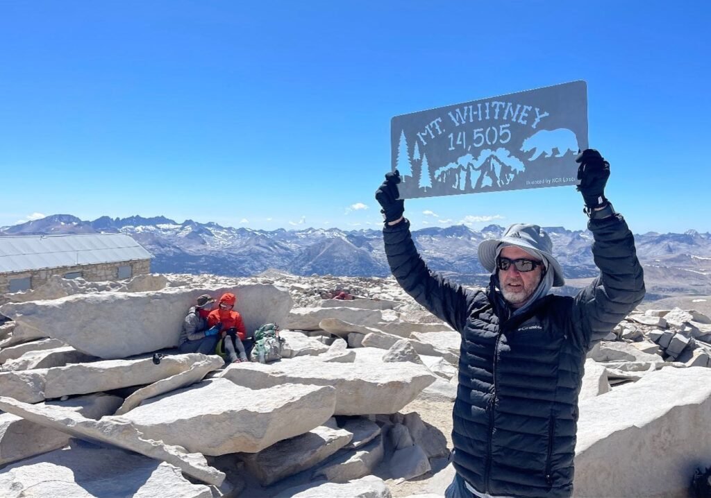 Peter Pendleton holding the Mt. Whitney 14,505 ft summit sign