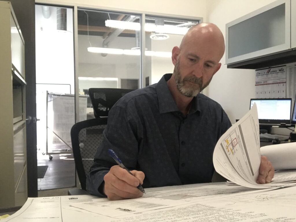 Peter Pendleton reviewing plans and documents in the office