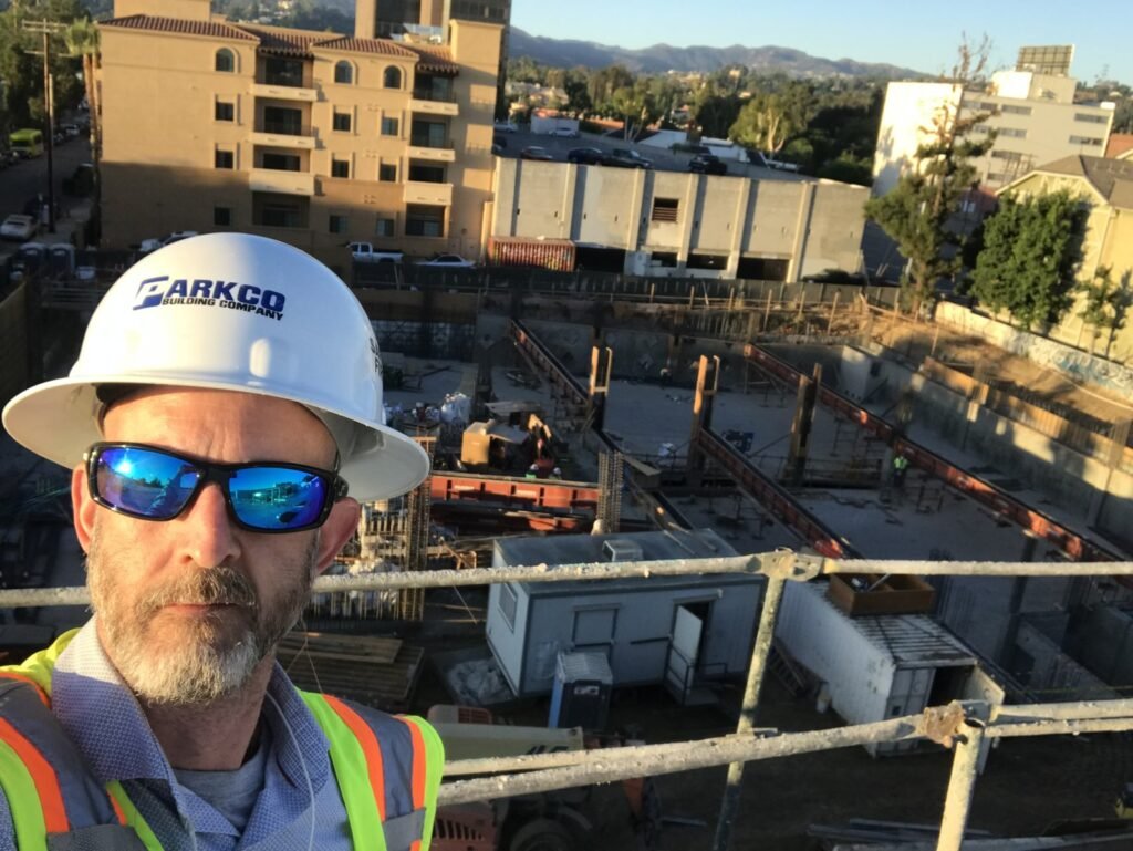 Peter Pendleton on scaffolding above a podium deck and shoring