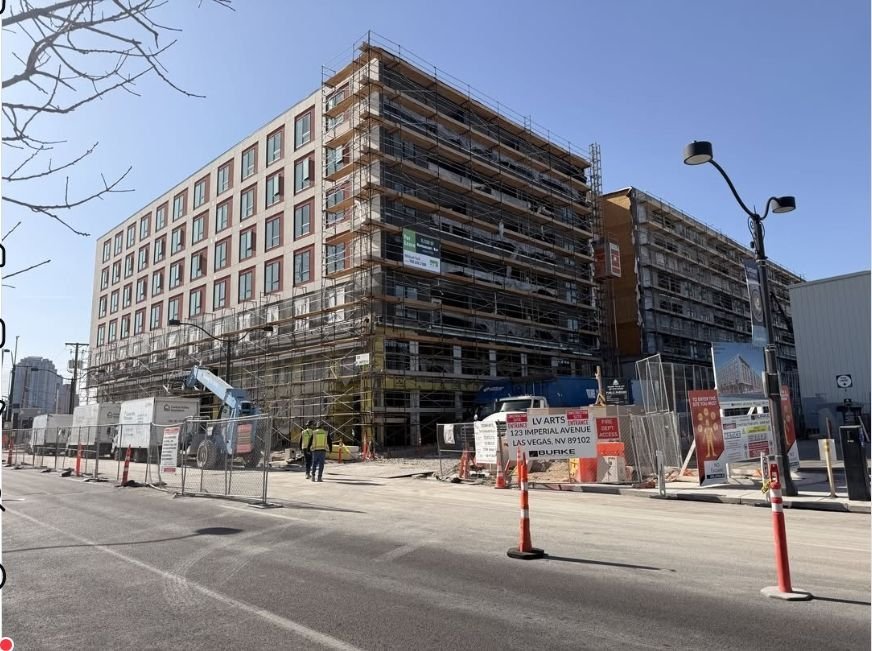 Seven-story multifamily building under construction in scaffolding